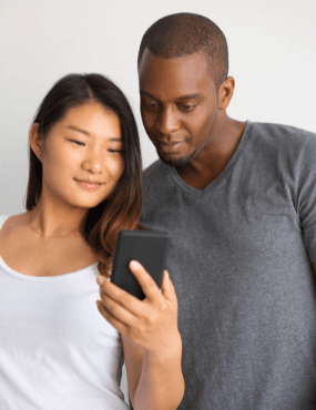 Couple looking at mobile telephone